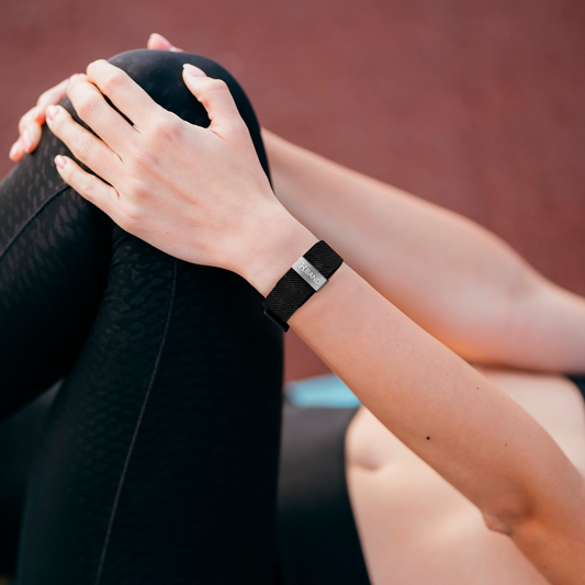 woman stretching wearing Hume Band